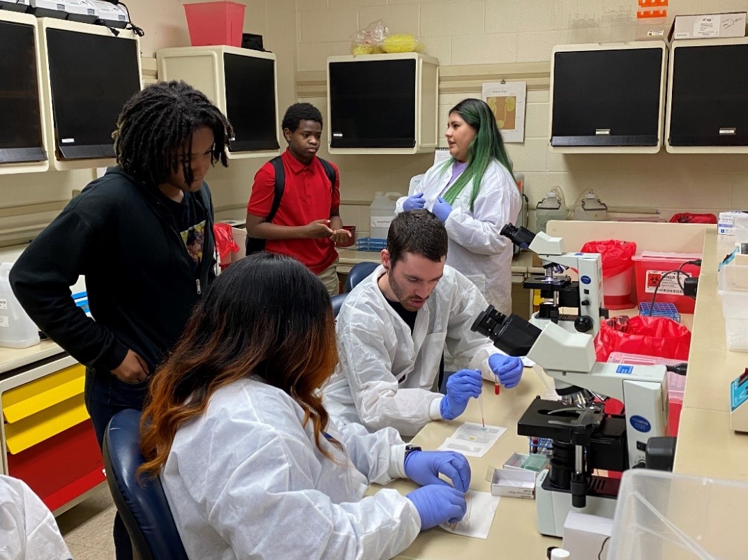 MLT students conduct a lab demonstration in hematology for MDHS students during service-learning day.  