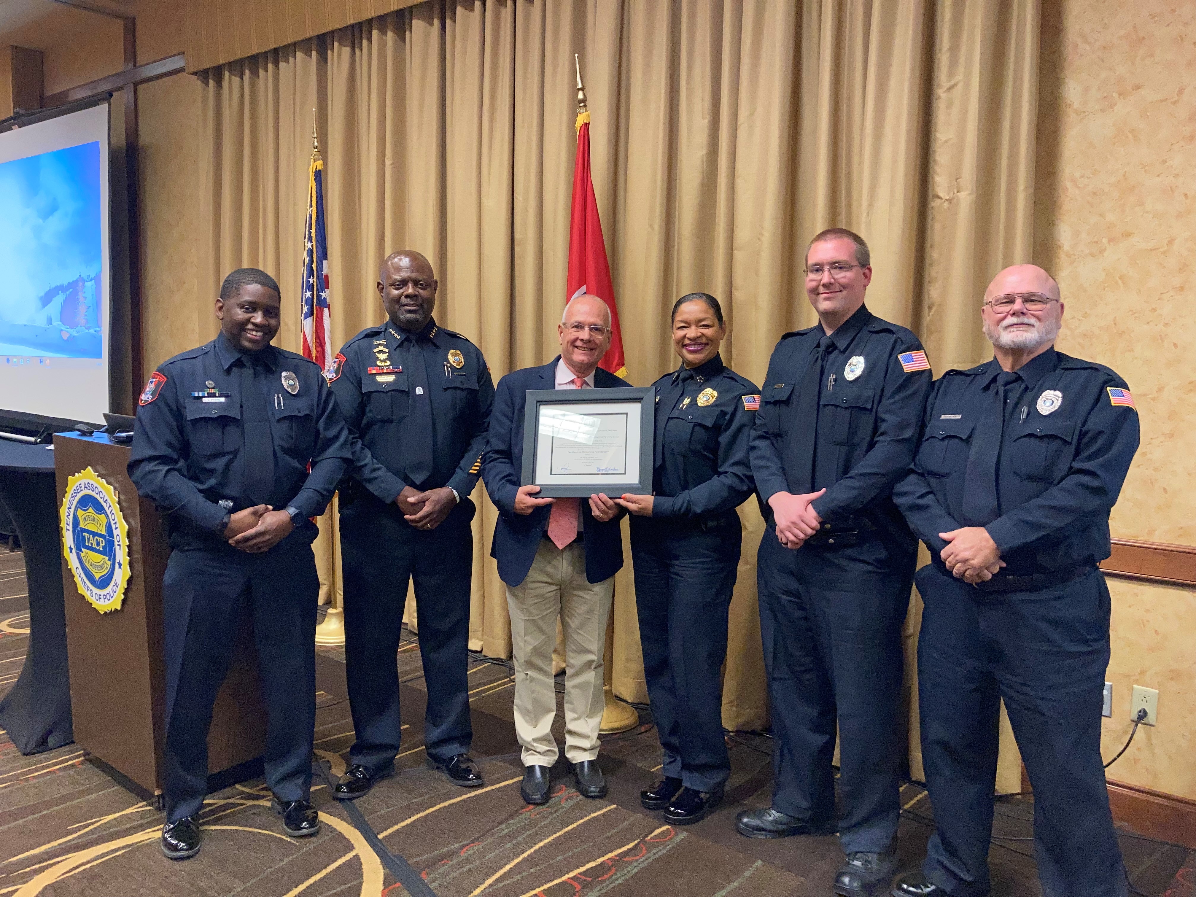 Southwest’s Public Safety and Police Services Director L. Angela Webb receives the department’s accreditation certificate from TACP President Mark Yother. Surrounding them are Southwest Officer Nigel Payne, Assistant Director Ernest Greenleaf and Officers Jon Burleson and Don Drewry.