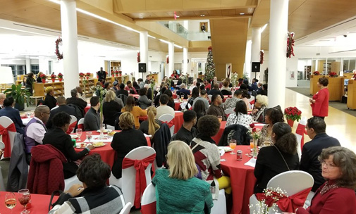 Attendees listen as Dr. Tracy Hall welcomes sponsors, donors, students and guests inside the lobby of the Bornblum Library at the 2018 Southwest Foundation holiday reception.