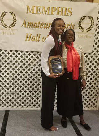Ashley Shields receives her Memphis Amateur Sports Hall of Fame plaque at the Hilton Memphis.