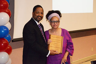Robinson presents Debra Frazier with the Outstanding Faculty Teamwork award. 