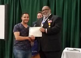 Hammam Alomari receives his honorable mention certificate in Short Fiction. 