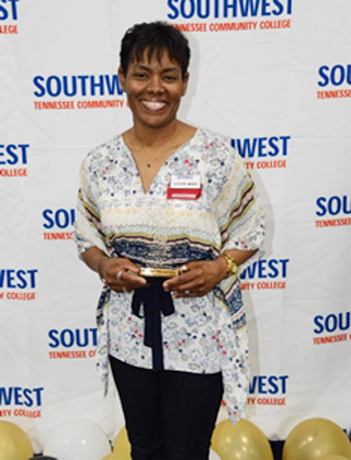 LaShunna Jackson beams with her Support Staff Employee of the Year award.