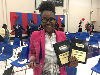 Honors Scholar of the Year Ashunna Curtis showcases her awards.