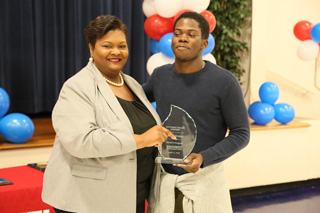 Vice-President of Student Affairs Jacqueline Faulkner presents the SMARTS Outstanding Scholastic Achievement Award to Khalil Hodges.