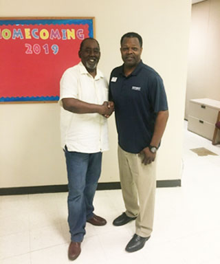 PASO President Ed Ashworth congratulates Worthy on his Employee of the Month award.