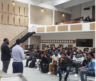 Hennings and Aquilar-Vazquez offer advice on the college admissions process to students at the Memphis Academy of Health Sciences High School. 