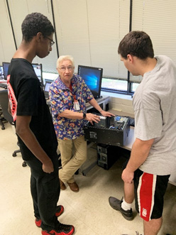 Brenda Phillips explains various computer components to Davioeous Stewart and Zachary Paulson.