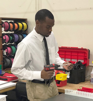 Brian Crutcher assembles products at his desk at Kele.