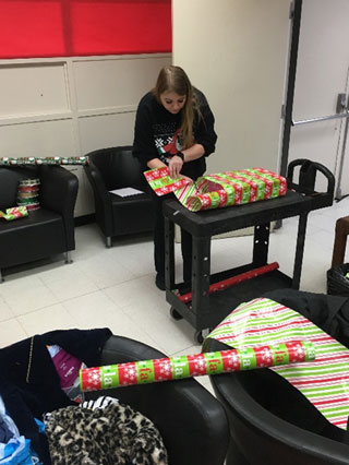 SGA volunteers wrap angel tree gifts for adopted students at Alton Elementary School.