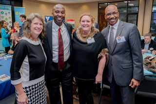 Southwest VP for Financial and Administrative Services Mike Neal (send from left) and Foundation Board Trustee Albert Glenn (far right) network with breakfast attendees. 