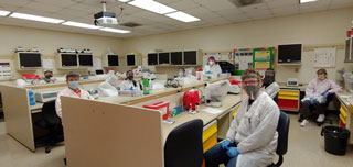 Students in the fall semester 2020 Medical Laboratory Technology Urinalysis/Body Fluids class are suited up to learn sitting 6 feet apart with face masks, face shields and gloves.