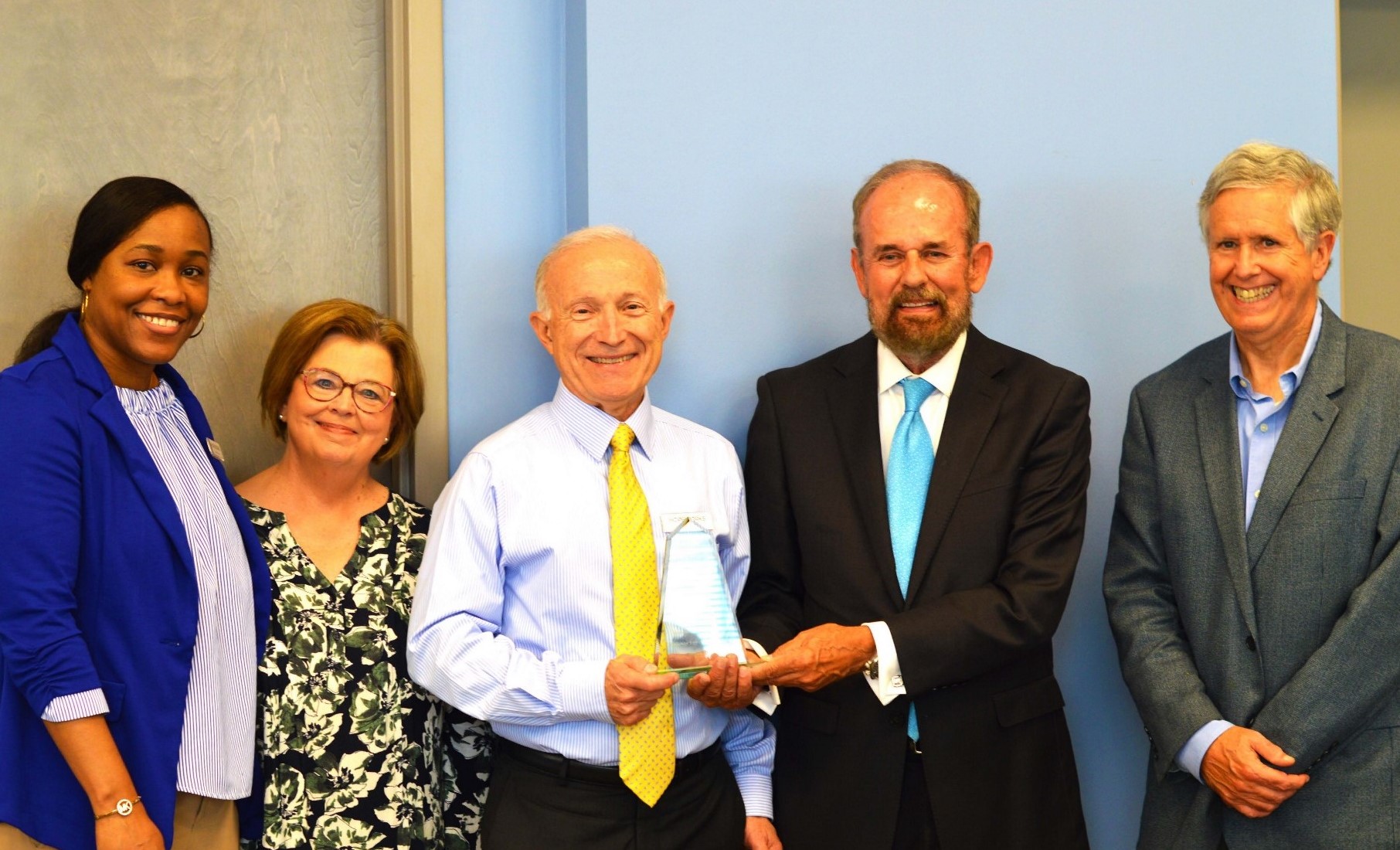 Hopeworks staff receive their coveted 2020 Chamber Quality Cup Award on Aug. 2, 2021 from MSQPC Executive Director Dr. Donald Fisher.