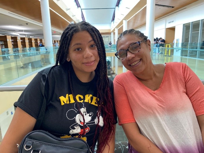 Incoming student Aysha, pictured with her mother inside the Bert Bornblum Library on the Macon Cove Campus, were happy to finalize paperwork for fall classes.