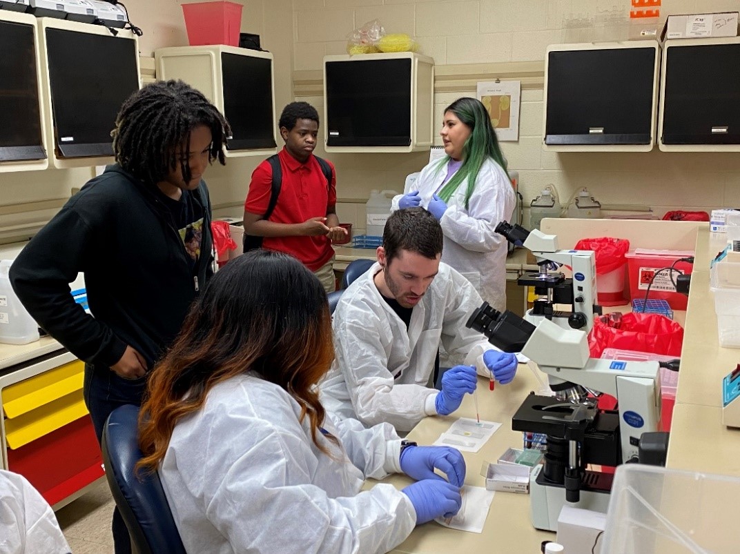 MLT students conduct a lab demonstration in hematology for MDHS students during service-learning day.