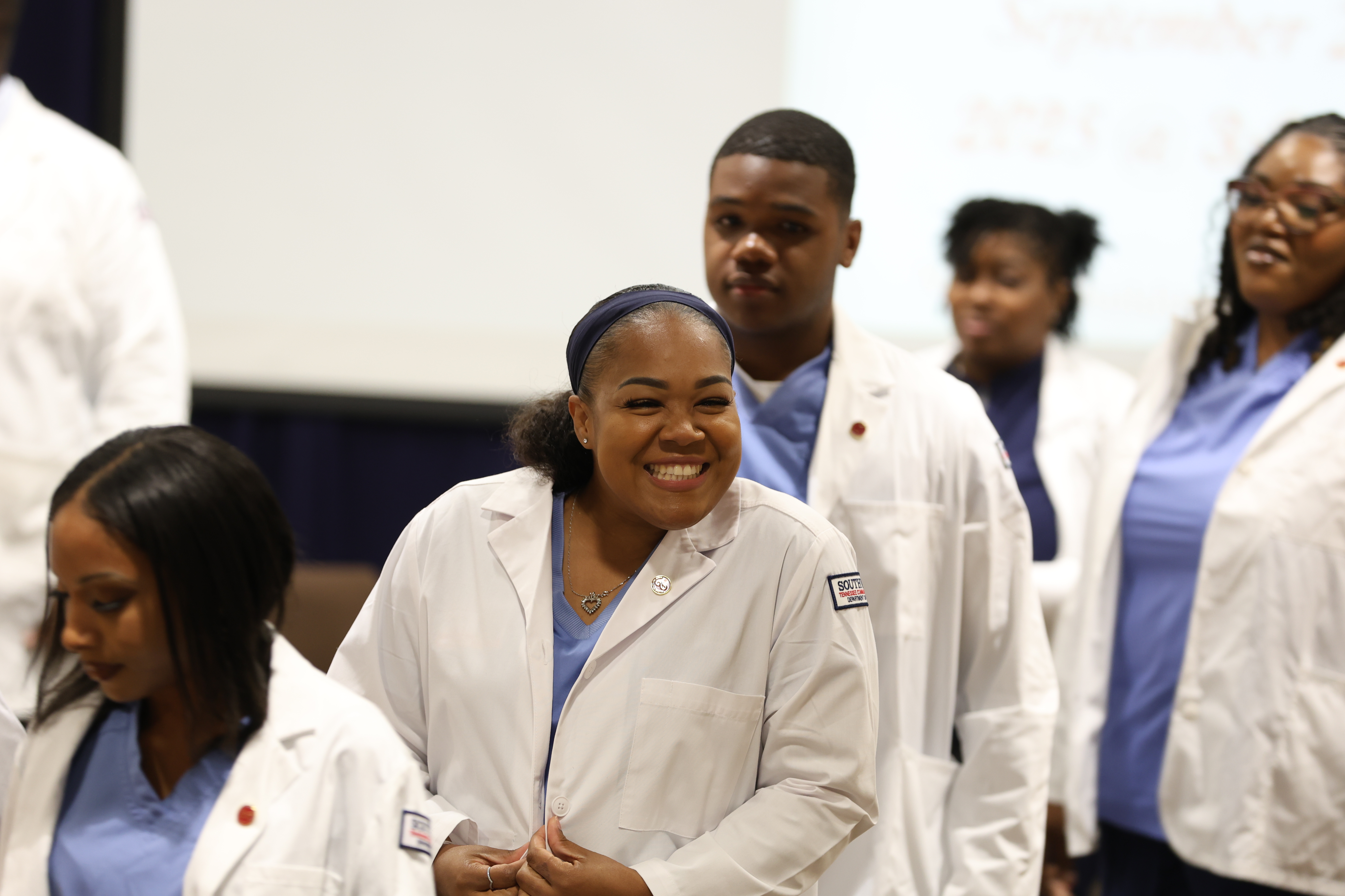 Surrounded by family and friends who offered cheers and support, 38 nursing students at Southwest Tennessee Community College mark the start of their professional journey at the annual White Coat Ceremony.